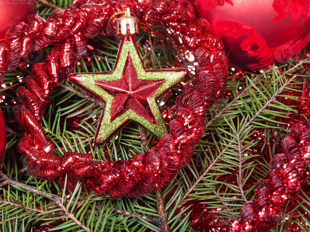 red star, tinsel on Christmas tree background photo