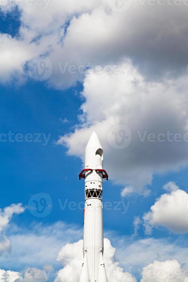 Vostok spacecraft and blue sky with clouds photo