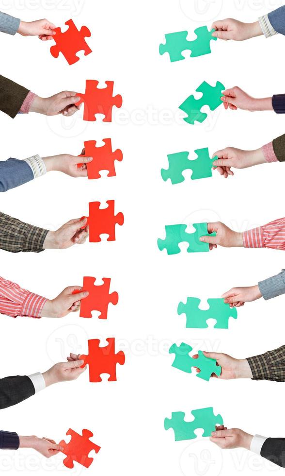 red and green puzzle pieces in people hands photo