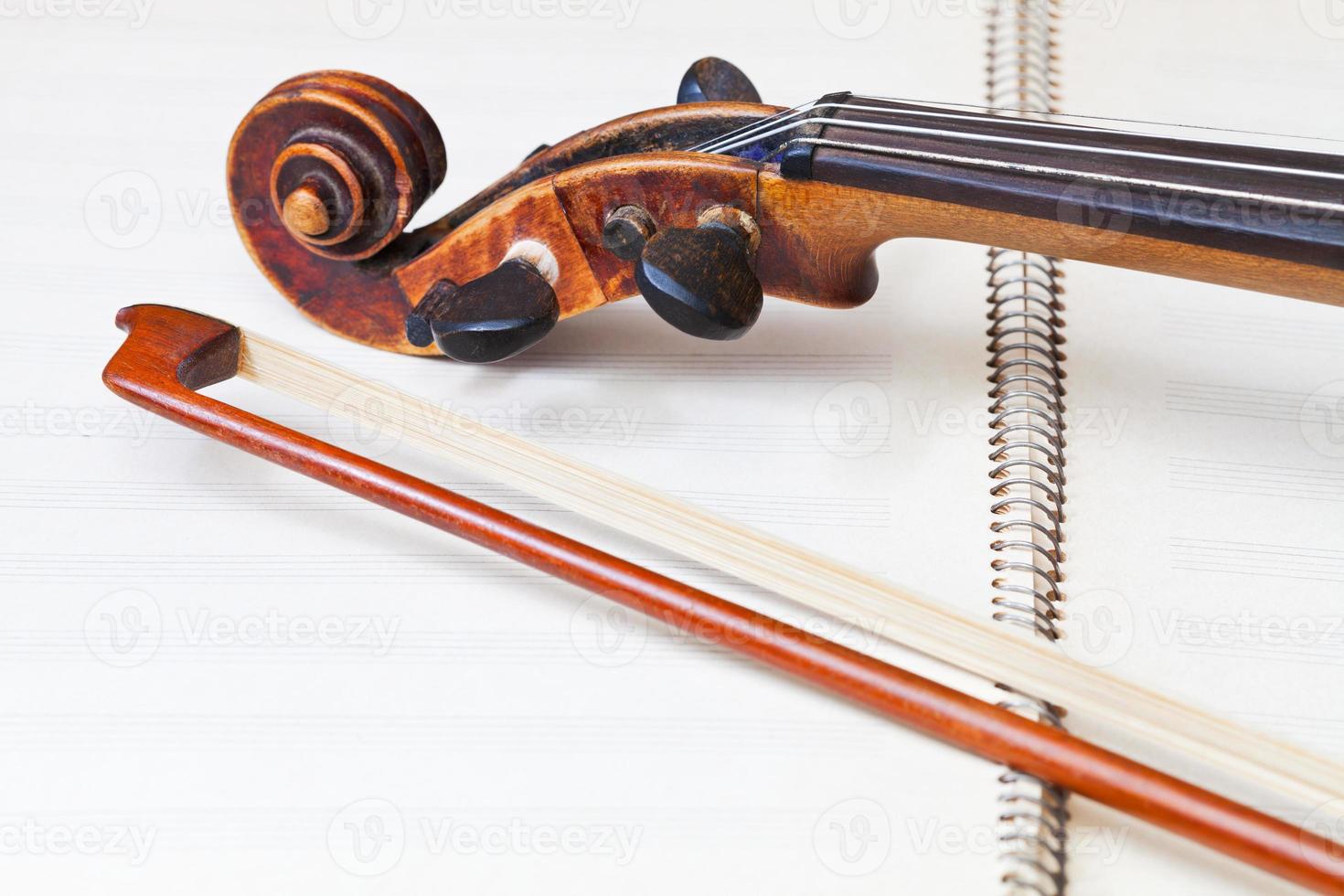 fiddle bow and scroll on music book photo