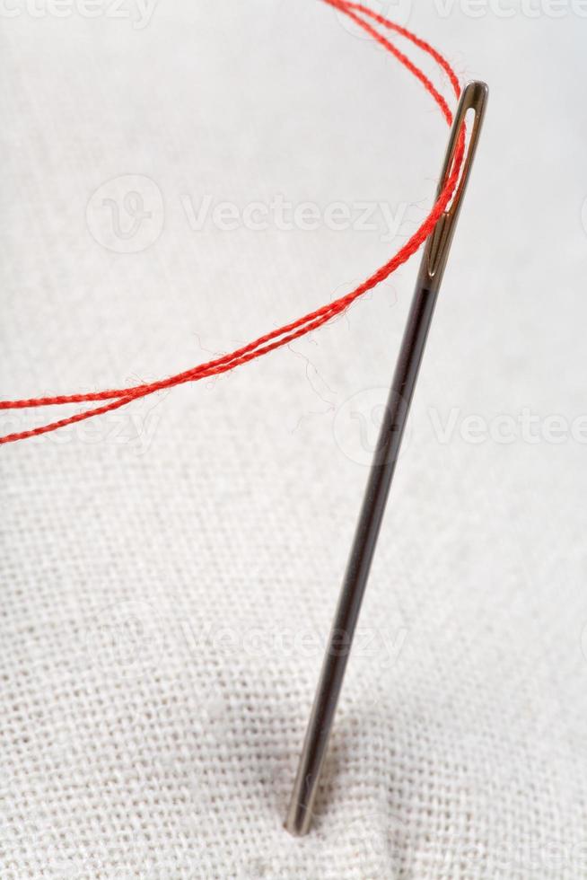 needle with red thread close up photo