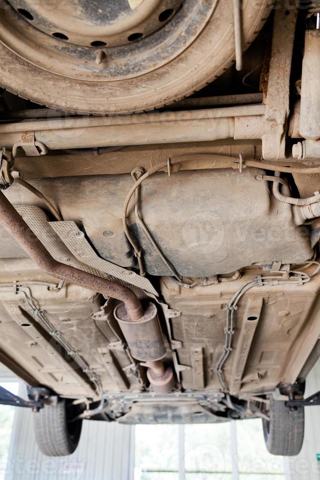 car lifted on auto hoist at repairing station photo