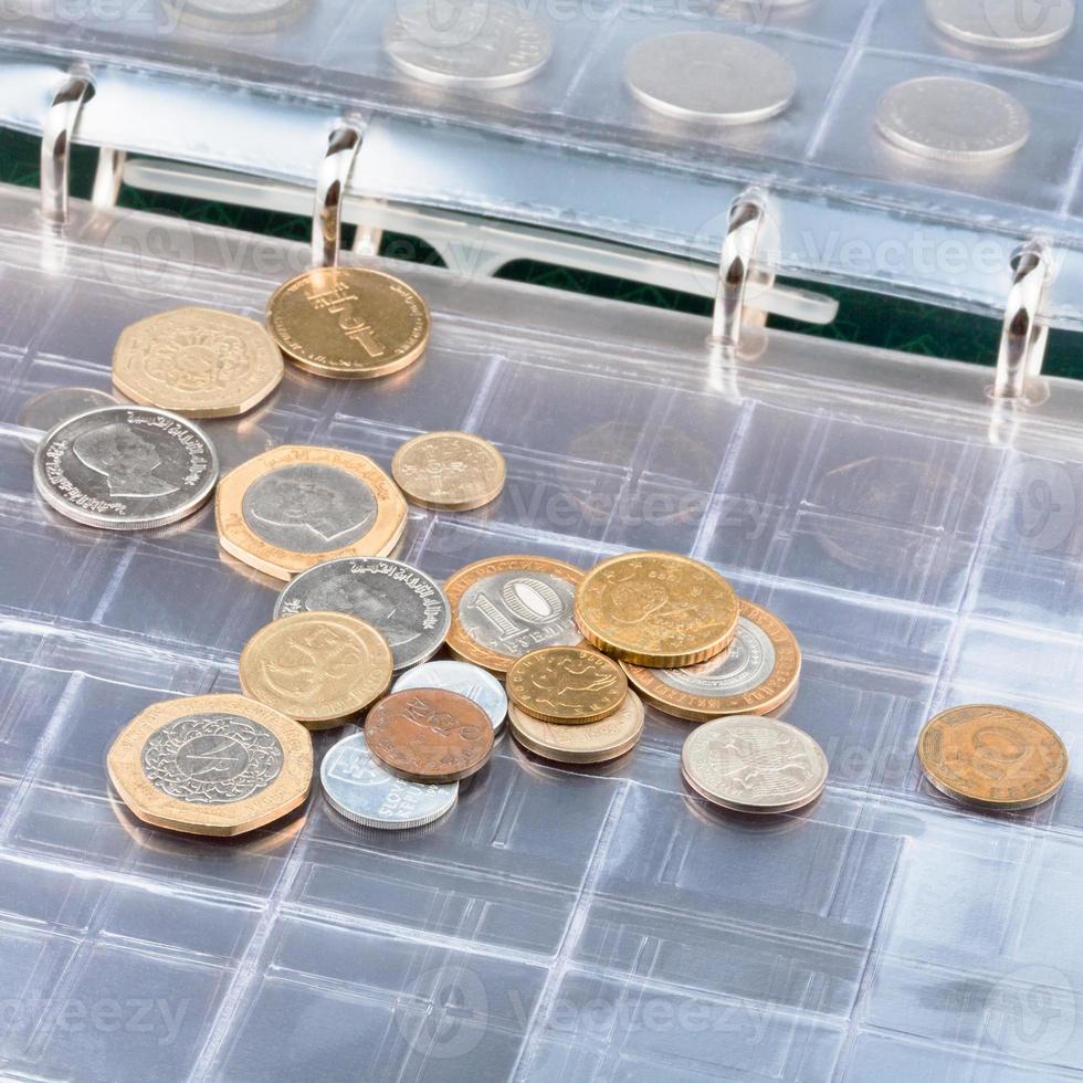 numismatics album with different coins photo