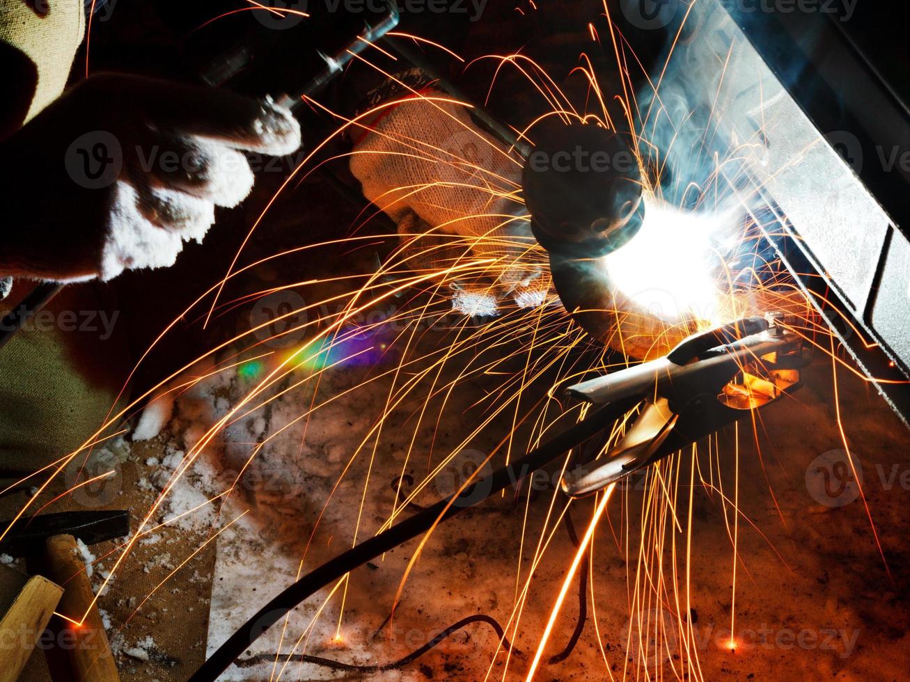 welding car turnbuckle in snow field photo