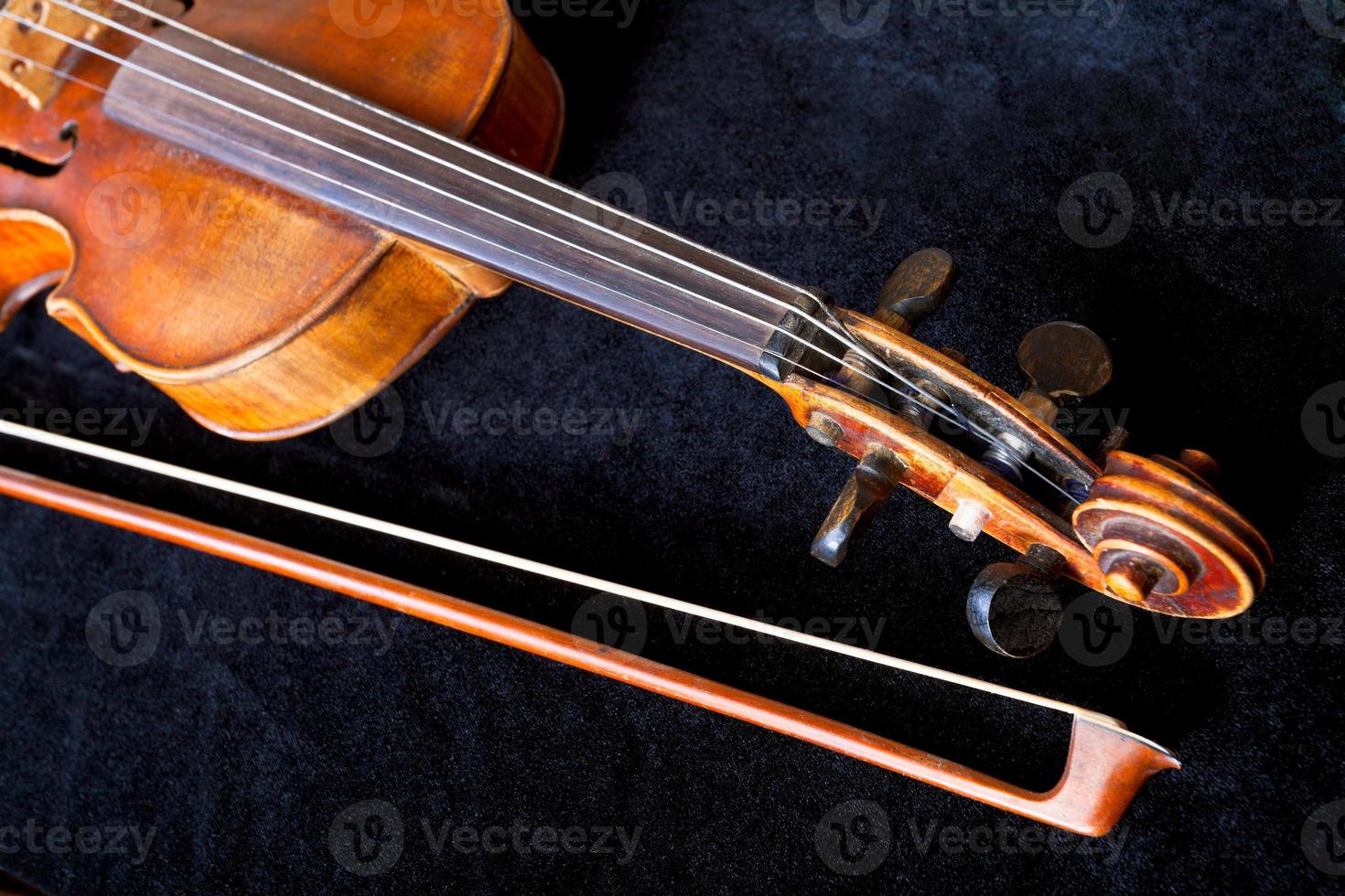 violin scroll and bow on black velvet photo