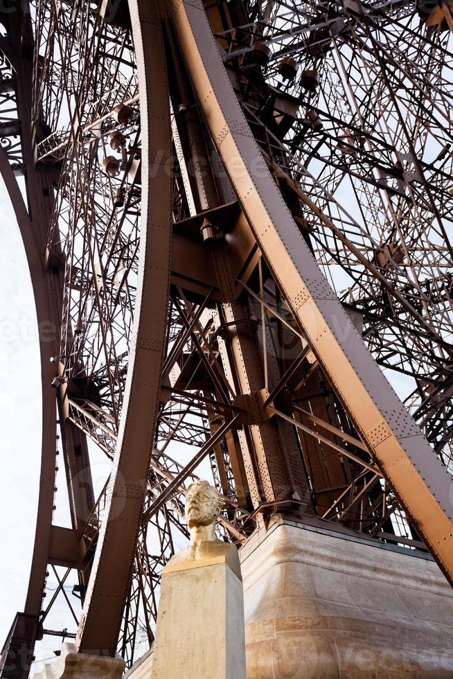 bust of Eiffel near tower photo