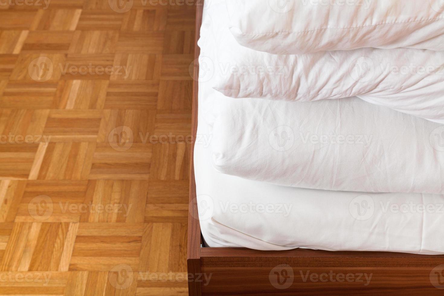 tucked blanket and bed sheet in double bed photo