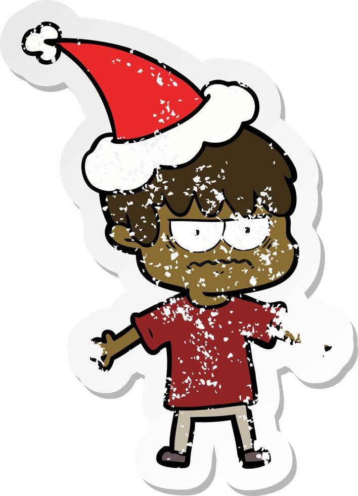 annoyed distressed sticker cartoon of a boy wearing santa hat vector