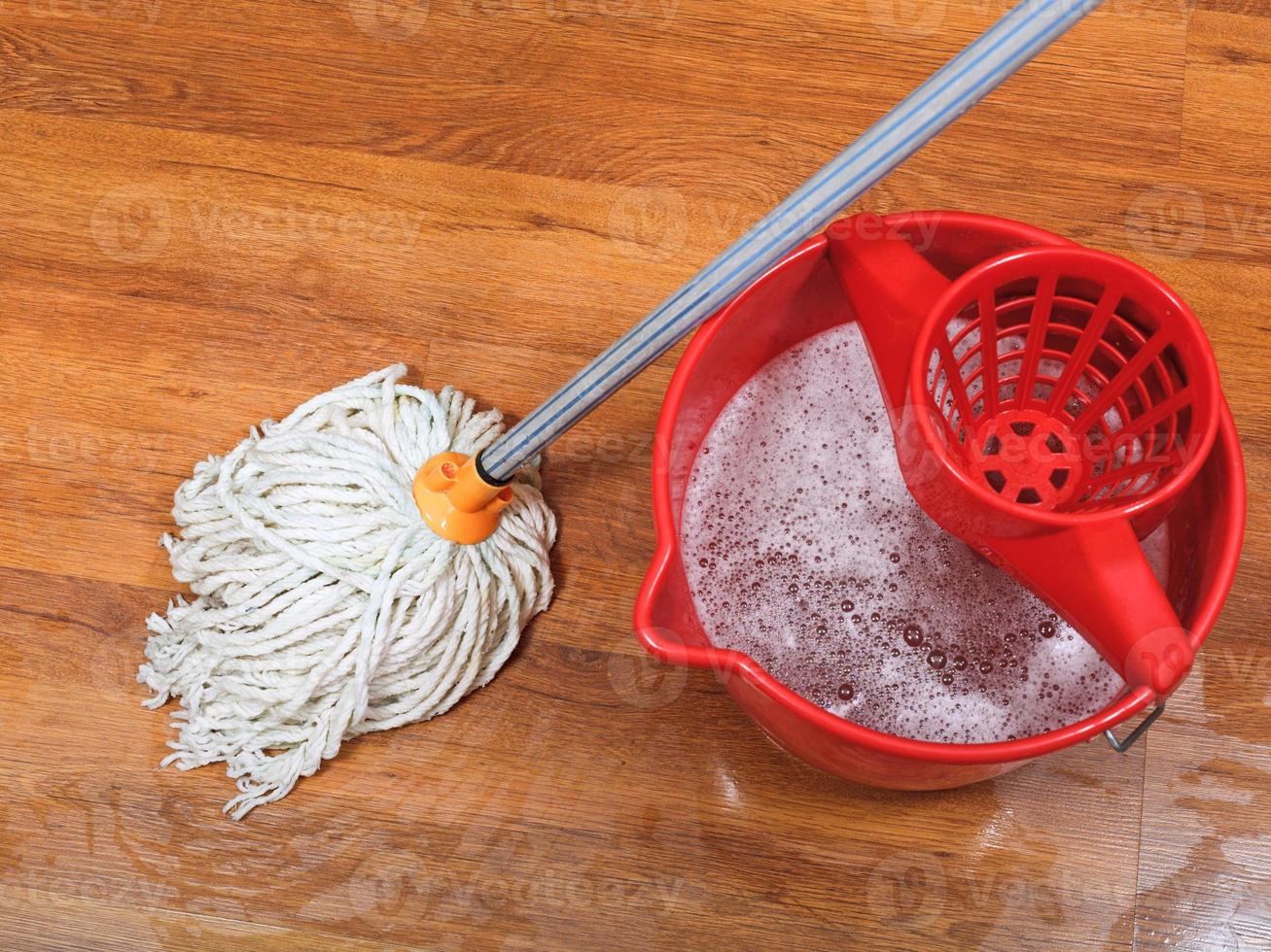 textile mop and red bucket photo