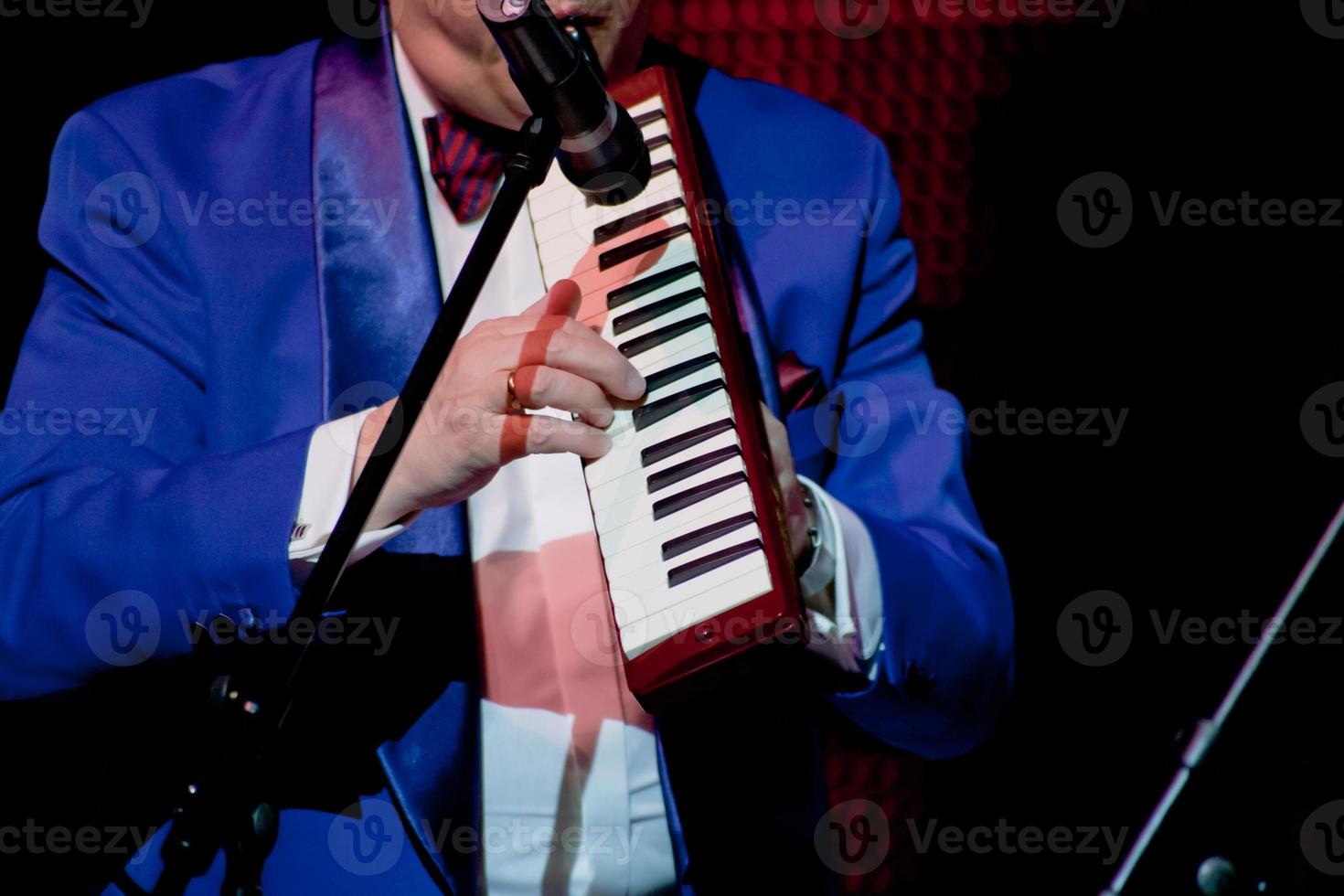 musician plays on melodica photo