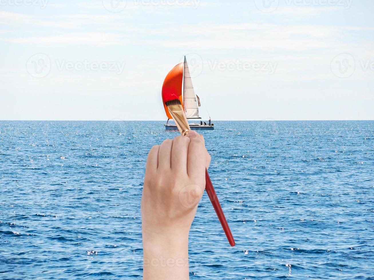 paintbrush paints red sail of yacht photo