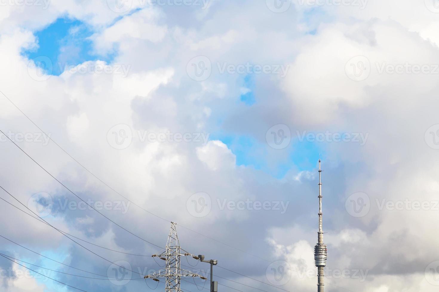 large white clouds over TV tower and power line photo