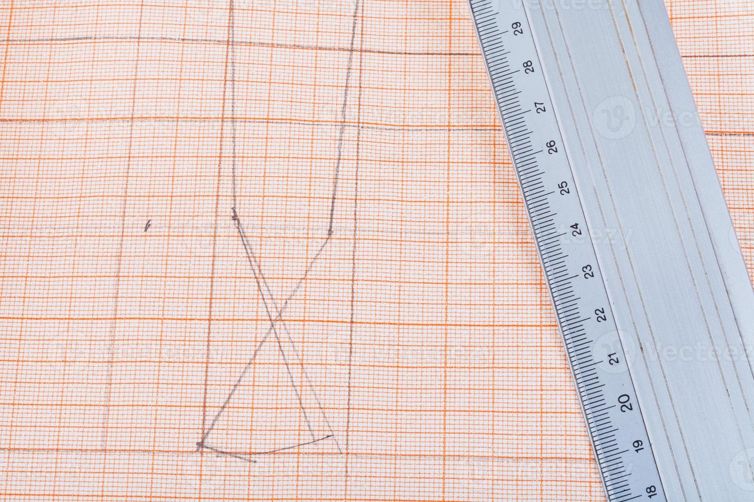 metal ruler at graph paper photo