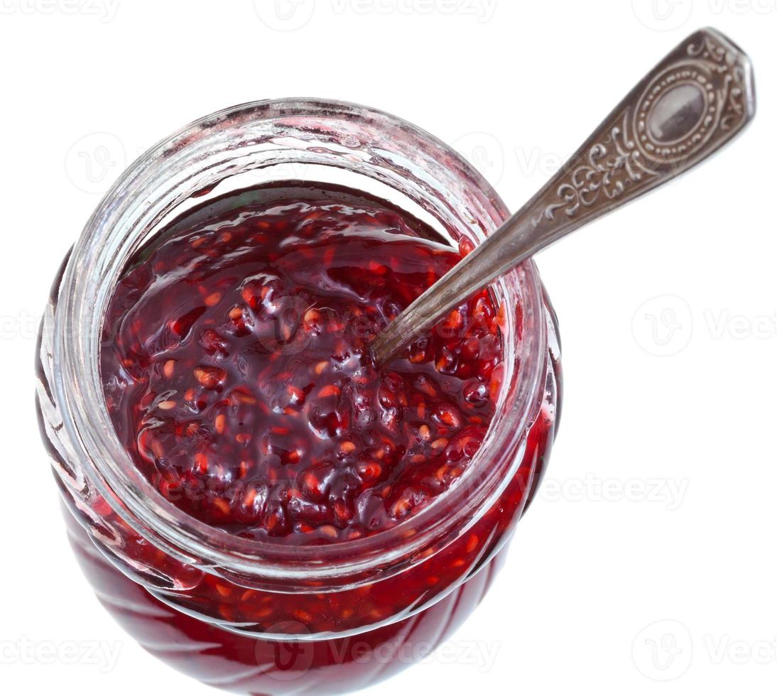 spoon in jar of raspberry jam photo