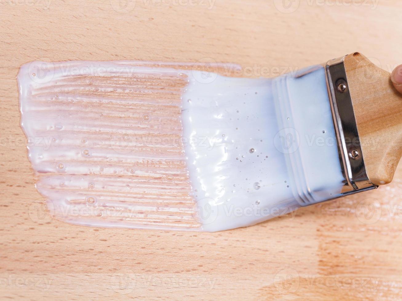 putting varnish on surface of beech worktop photo