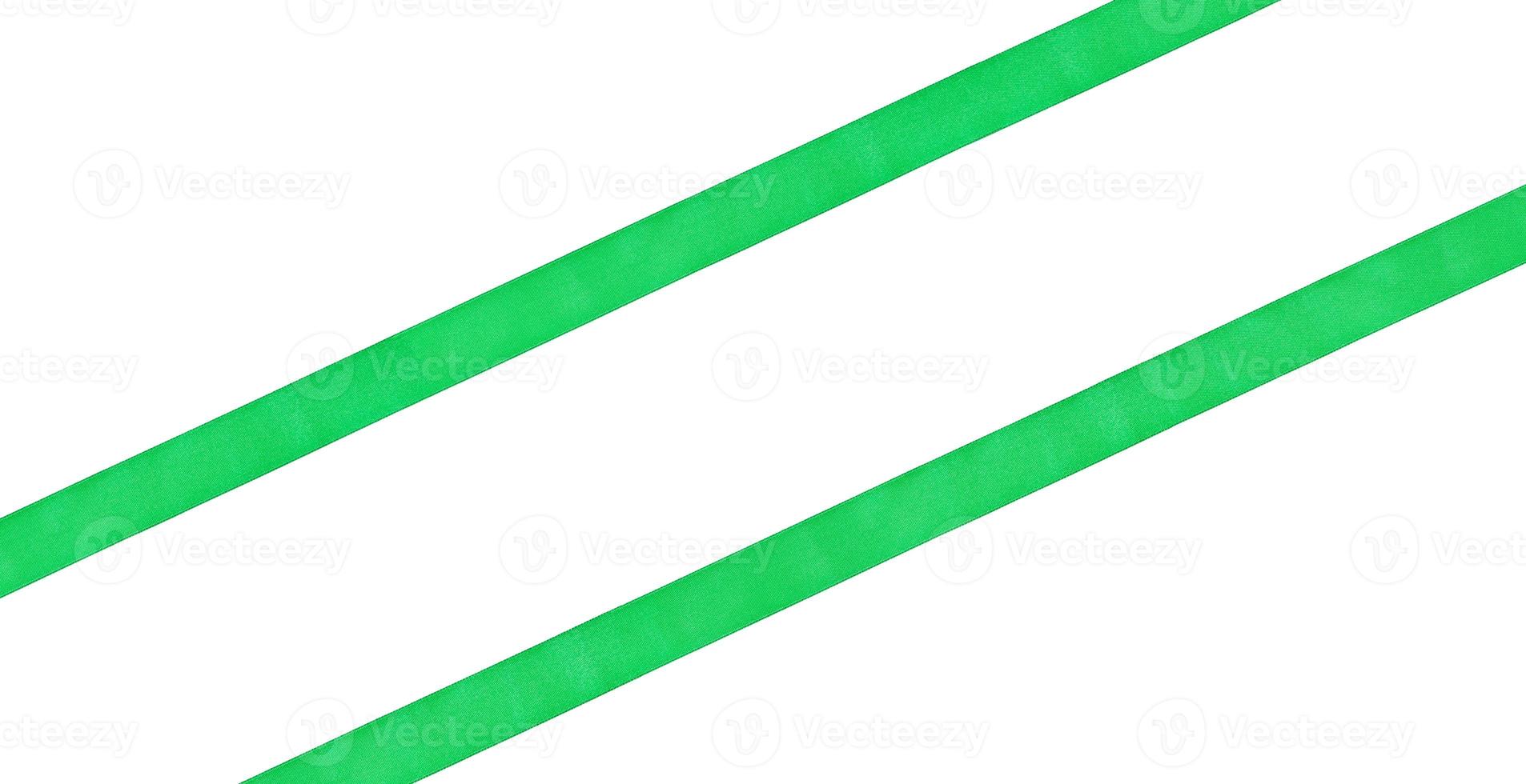 two diagonal parallel green satin ribbons photo