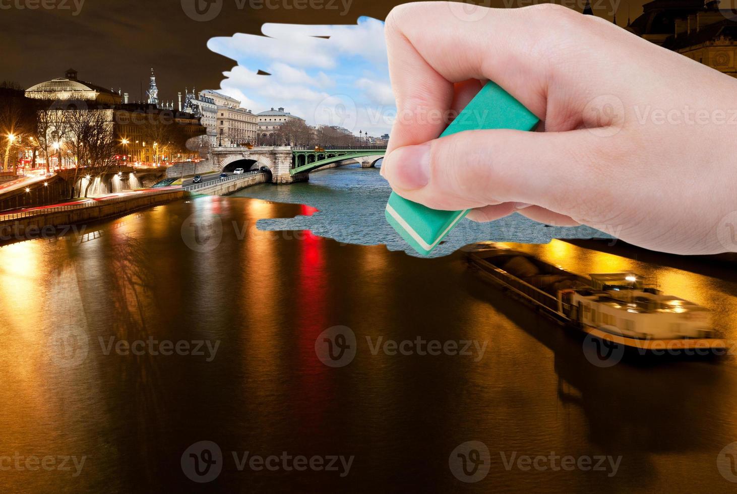 hand deletes night scenery of Paris city by eraser photo