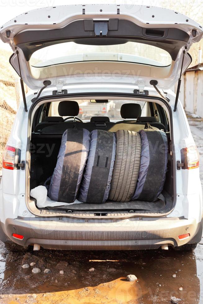 set of summer tires in boot of car photo