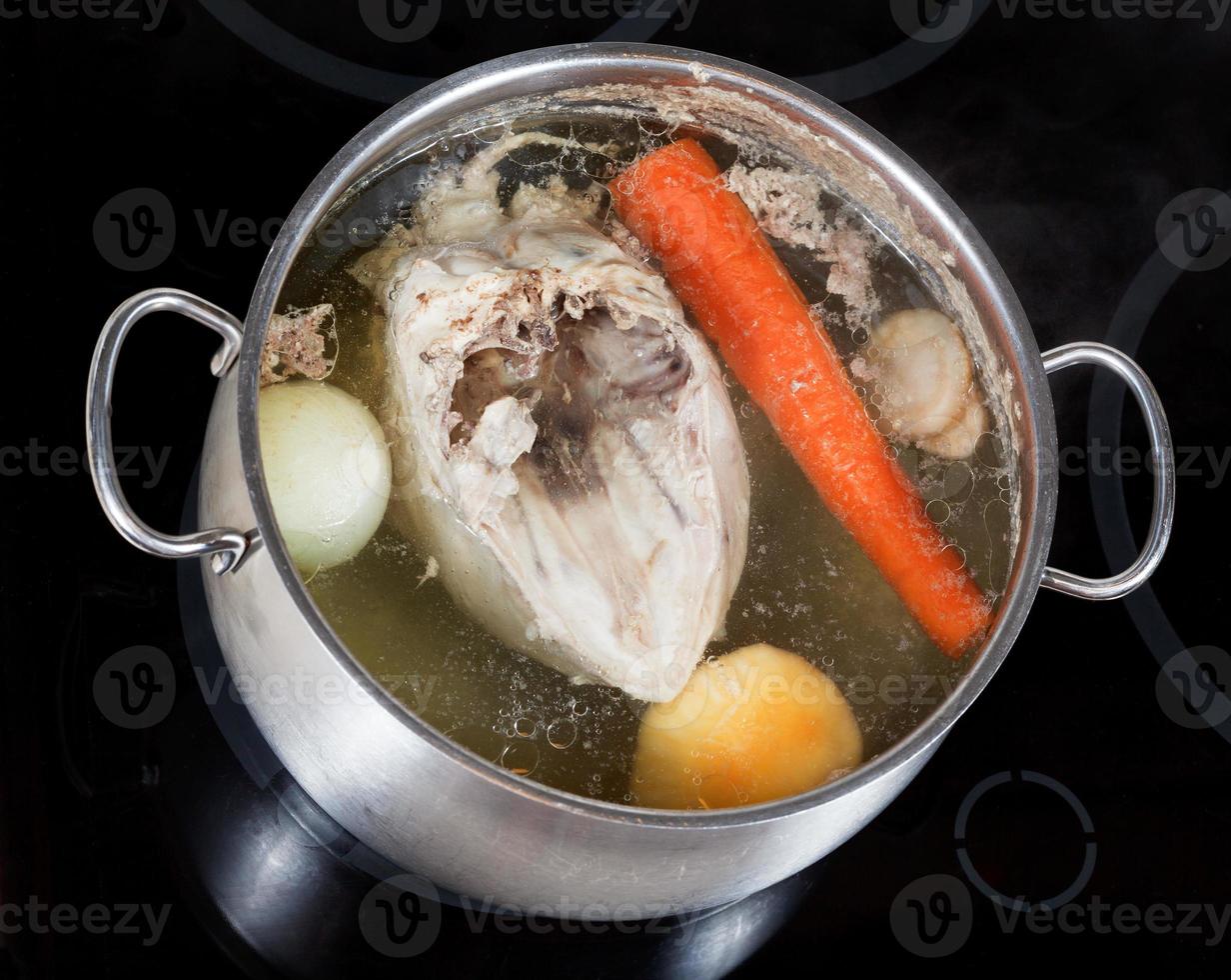 boiling of chicken broth with seasoning vegetables 11693587 Stock Photo