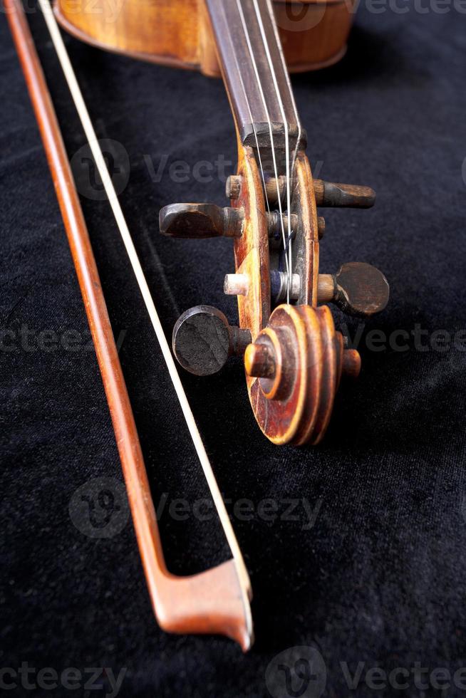 fiddle scroll and bow on black velvet photo