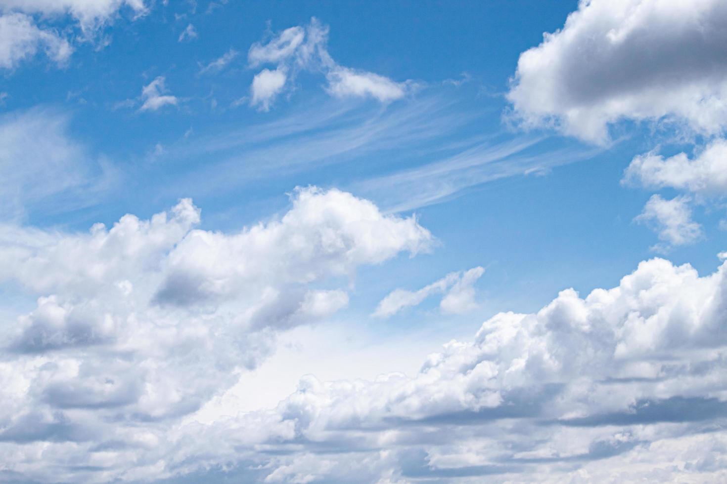 Cumulus clouds blown by the wind across the sky background. photo