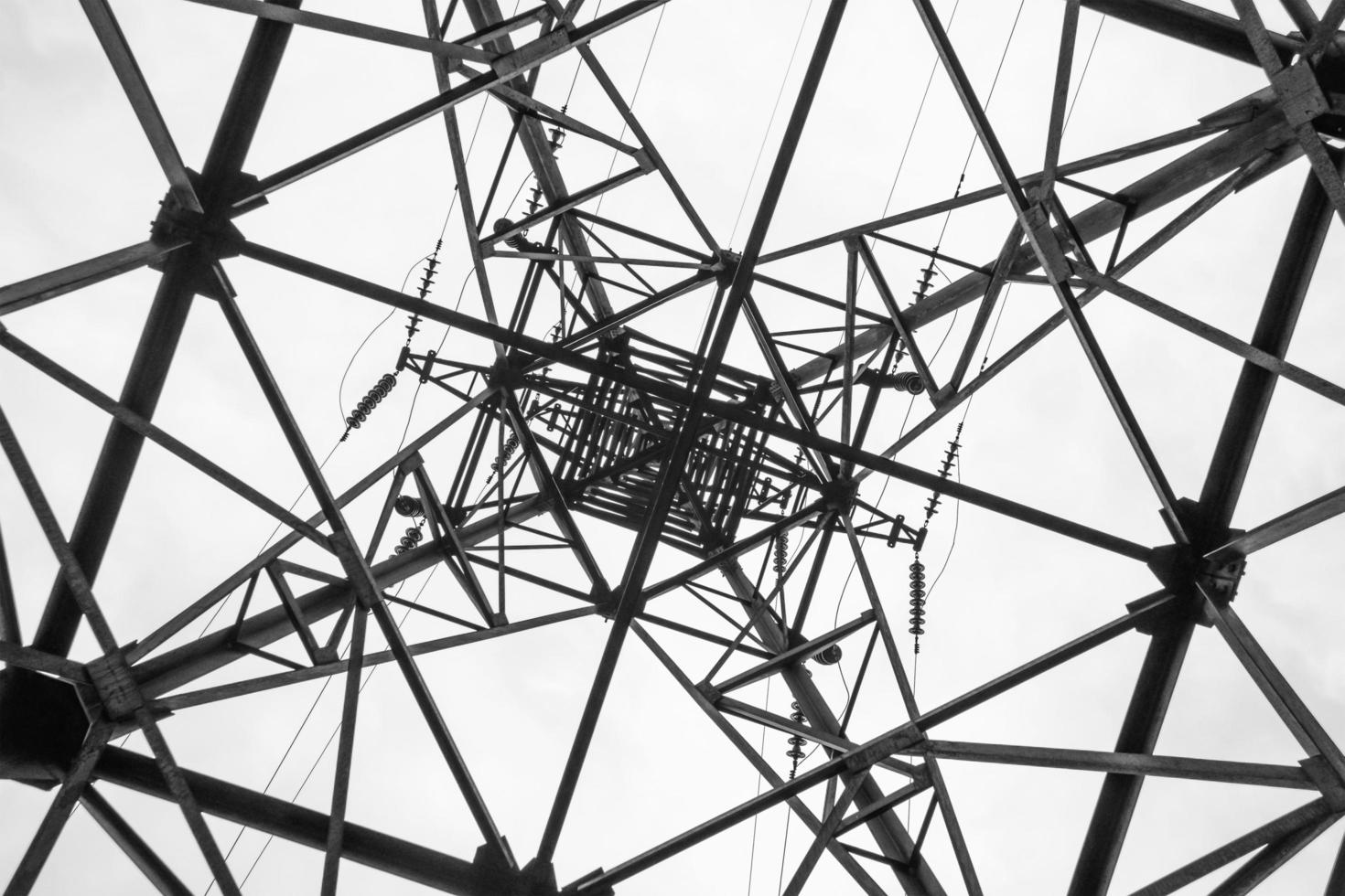 Bottom up view of electrical transmision high-voltage tower. photo