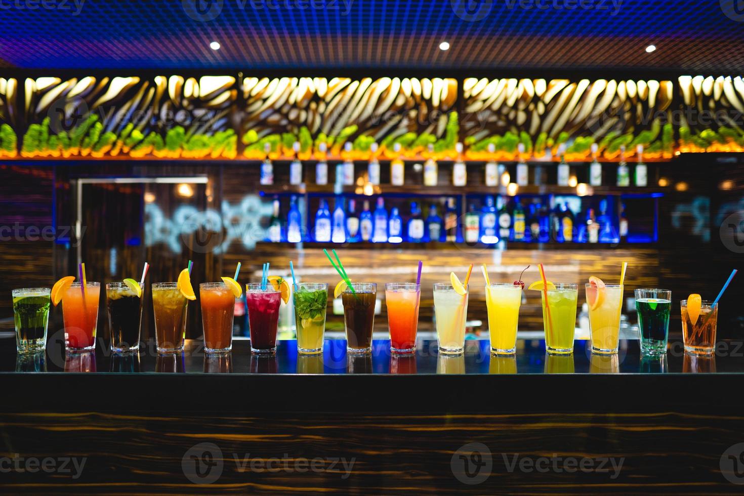 many different cocktails prepared by at the bar photo