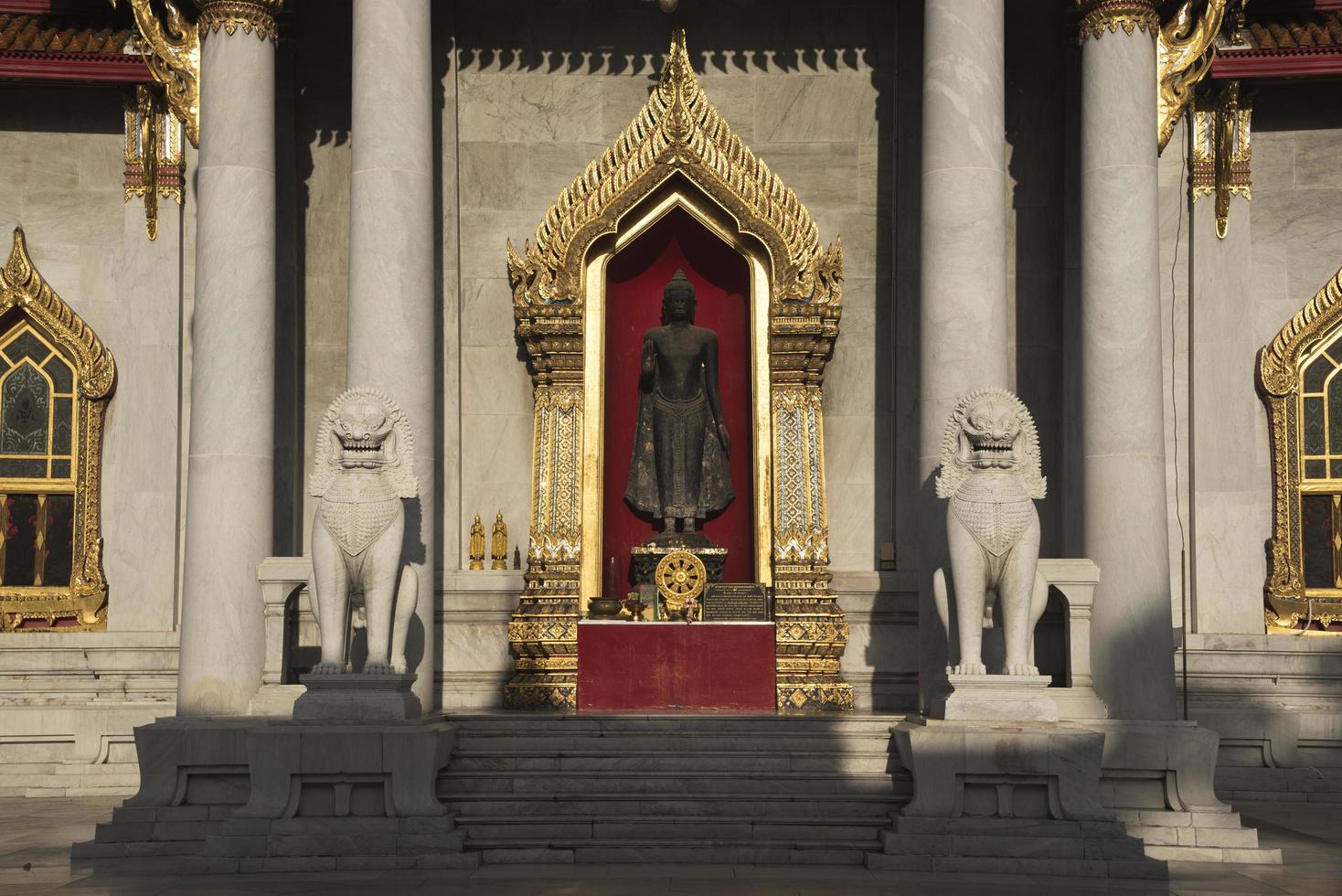 Buddha and lion statues at wat Benjamaborphit photo