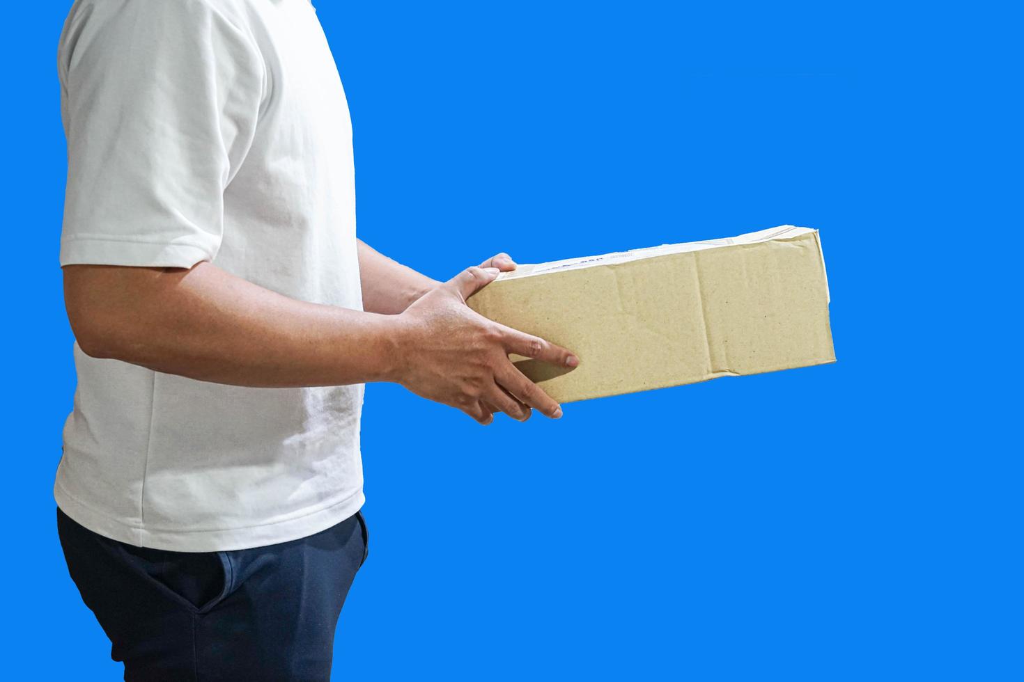 A man wearing a white t-shirt is delivering parcels to satisfied customers, friendly workers, and high-quality delivery service. photo