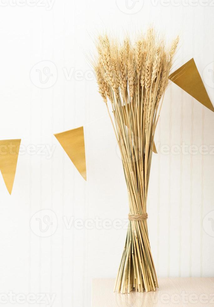 autumn harvest party celebrating. barley spiklets and bunting. vertical size. harvesting, agriculture concept photo