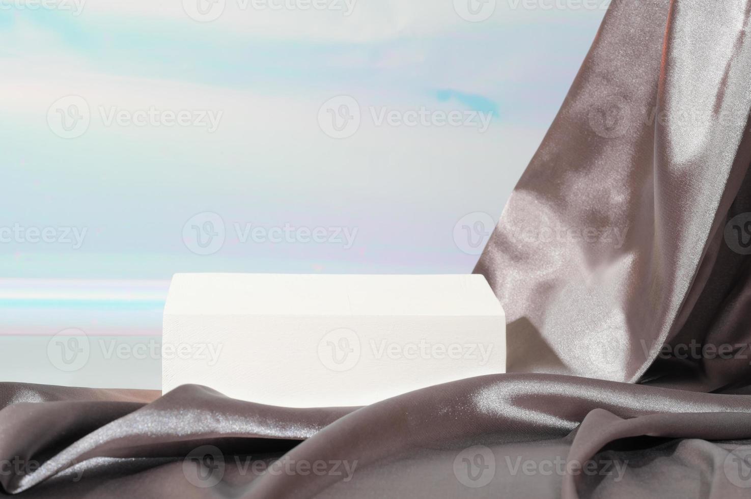 geometric white podium pedestal for self care product presentation. draped silk or satin fabric with pleats. skin care cosmetic or householding product display scene. photo