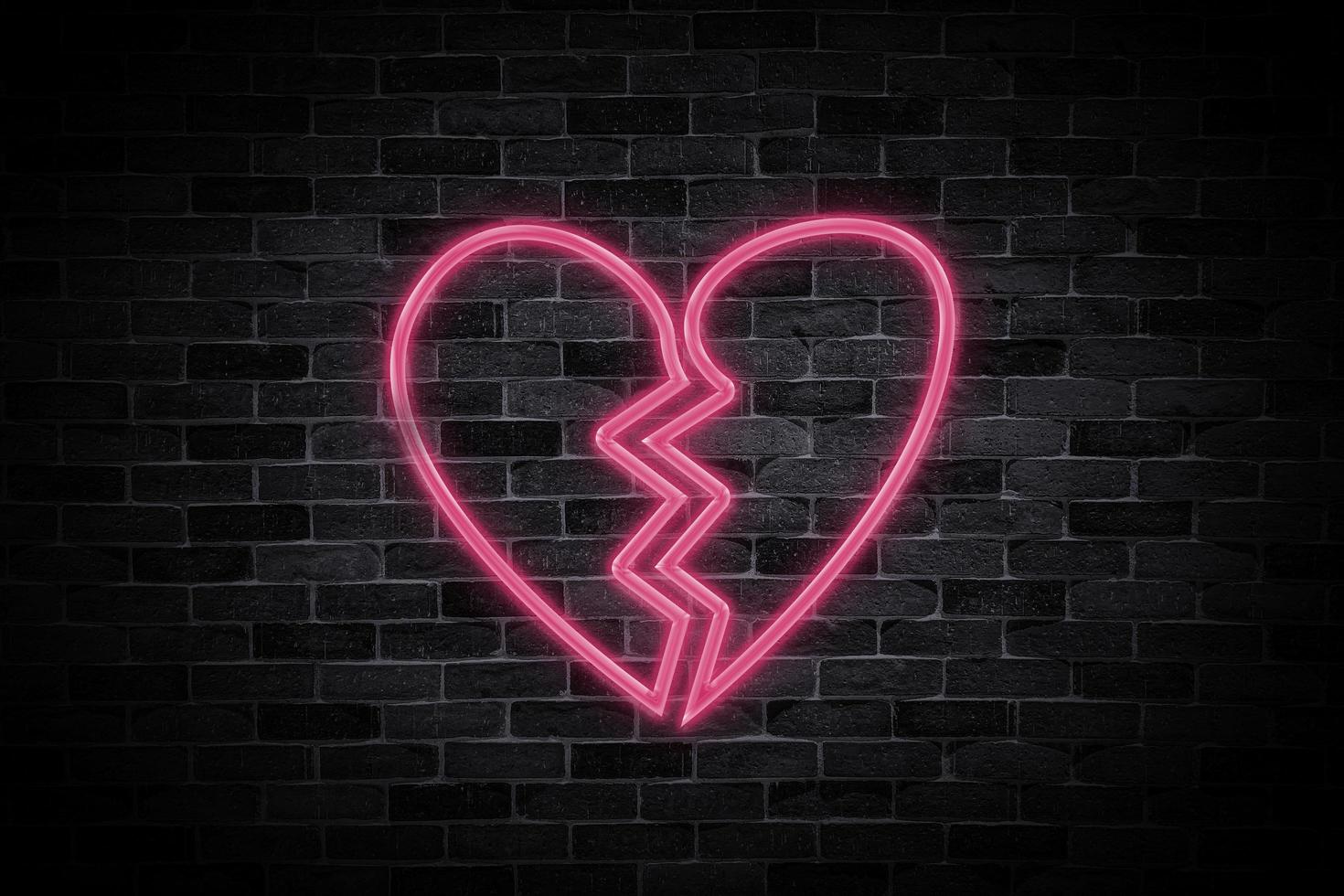 Heart broken sign symbol neon banner on brick wall background. photo