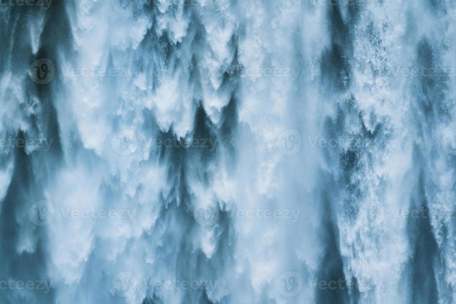 Powerful large natural waterfall flowing from cliff in summer photo