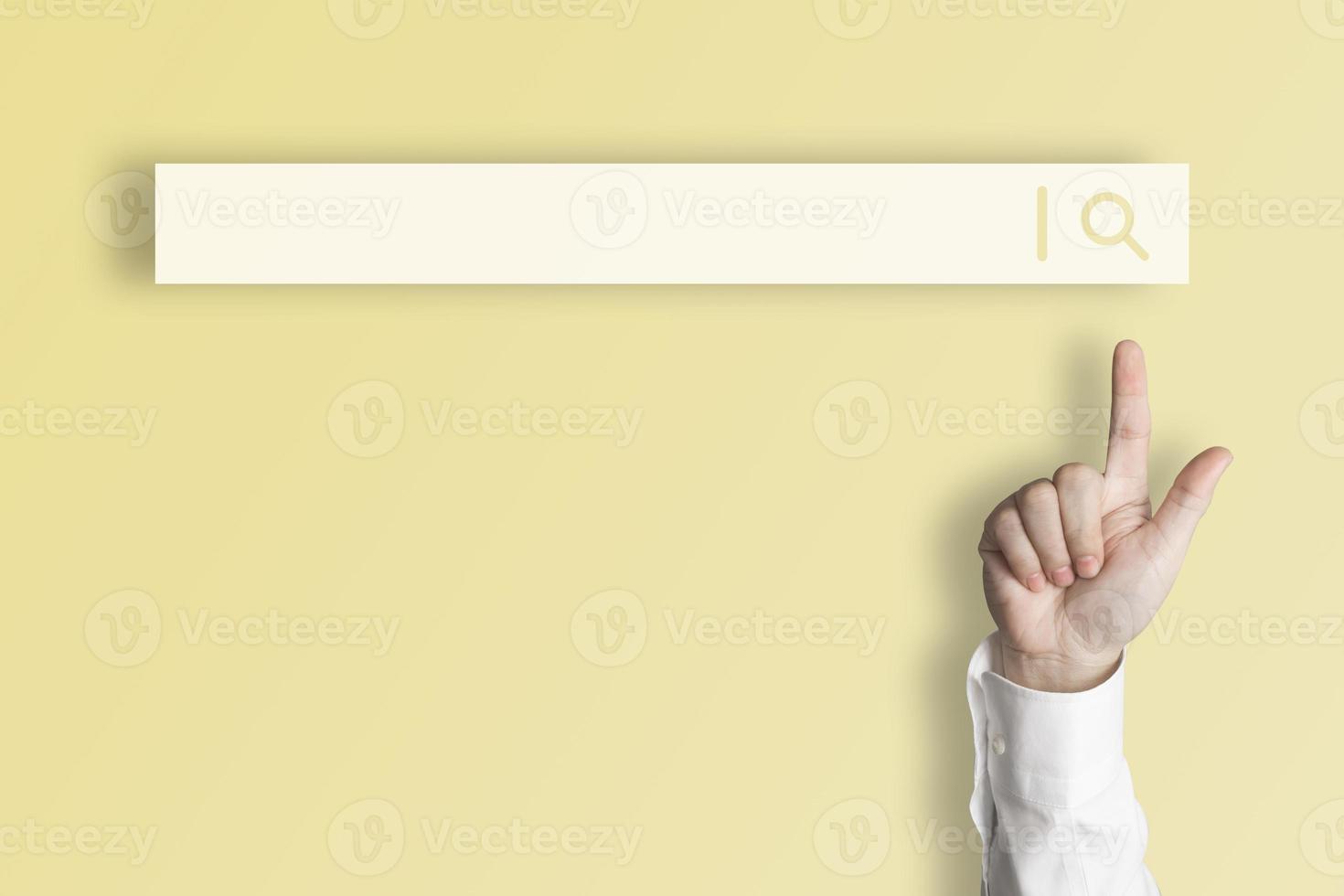 Businessman's finger pointing at internet search page on virtual touch screen Earth tone yellow background, search for internet surfing information network concept, education, knowledge, copy space photo