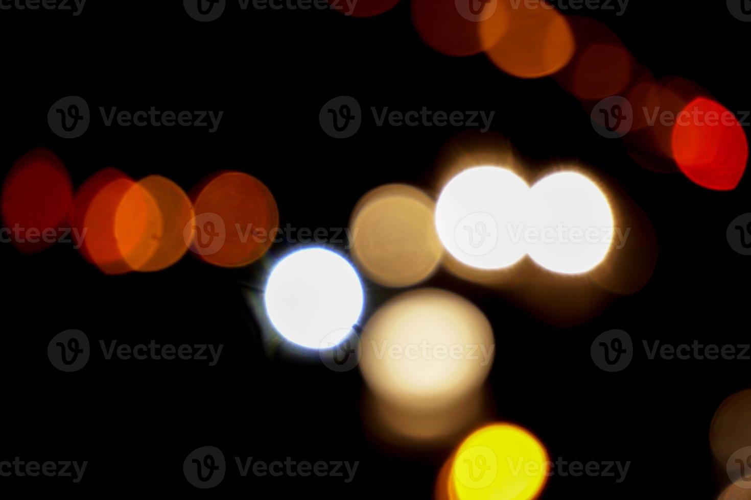 Abstract colorful bokeh reflection lighting on the road and black background. photo