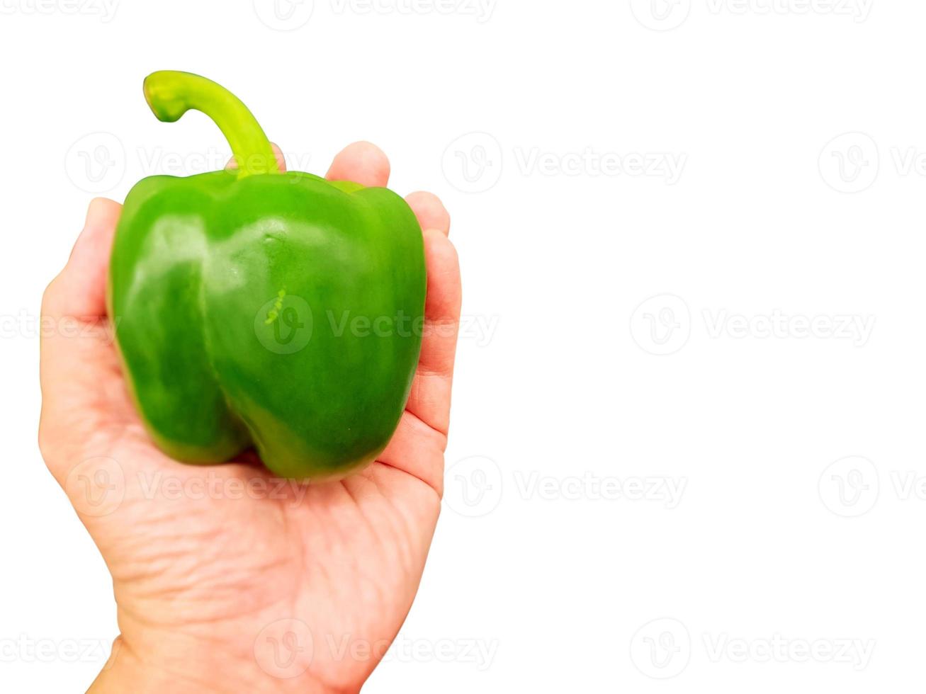 Hand of person holding a green bell pepper  isolate on white background and make with clipping paths. photo