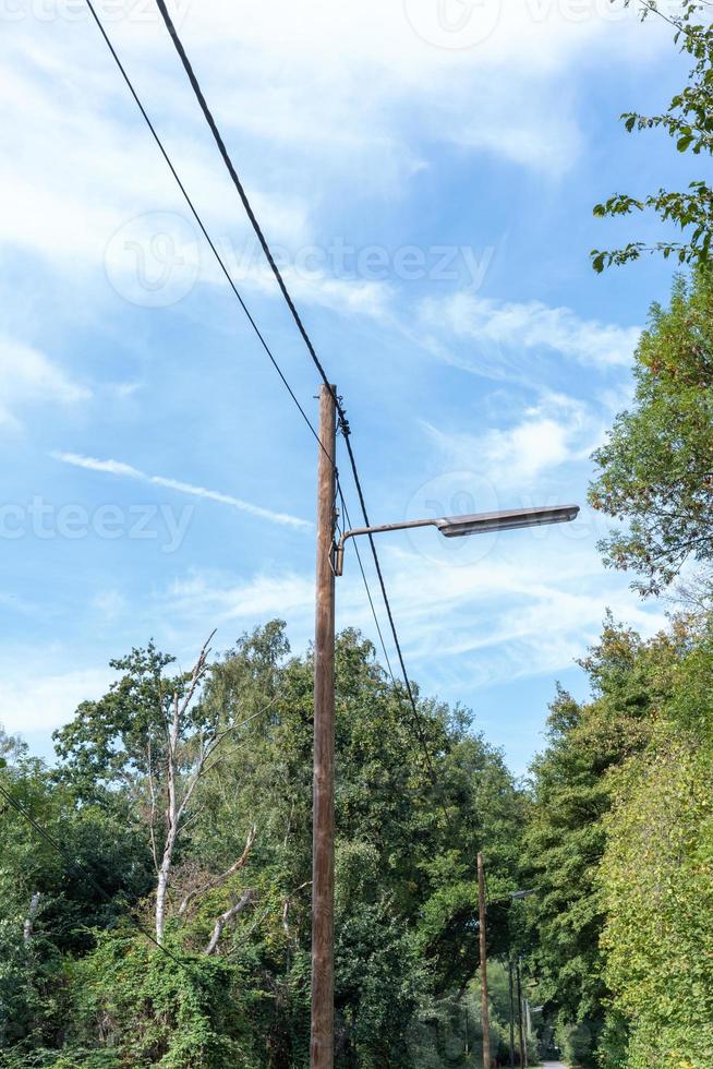 Street light with wooden pole in the countryside photo