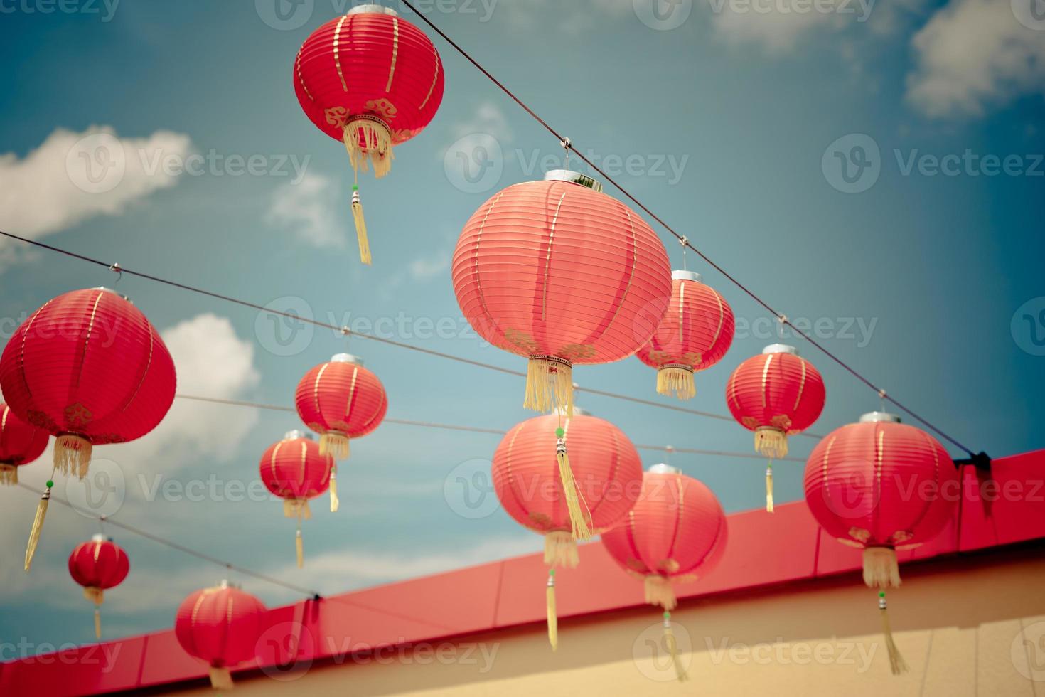 Red Chinese Paper Lanterns against a Blue Sky photo