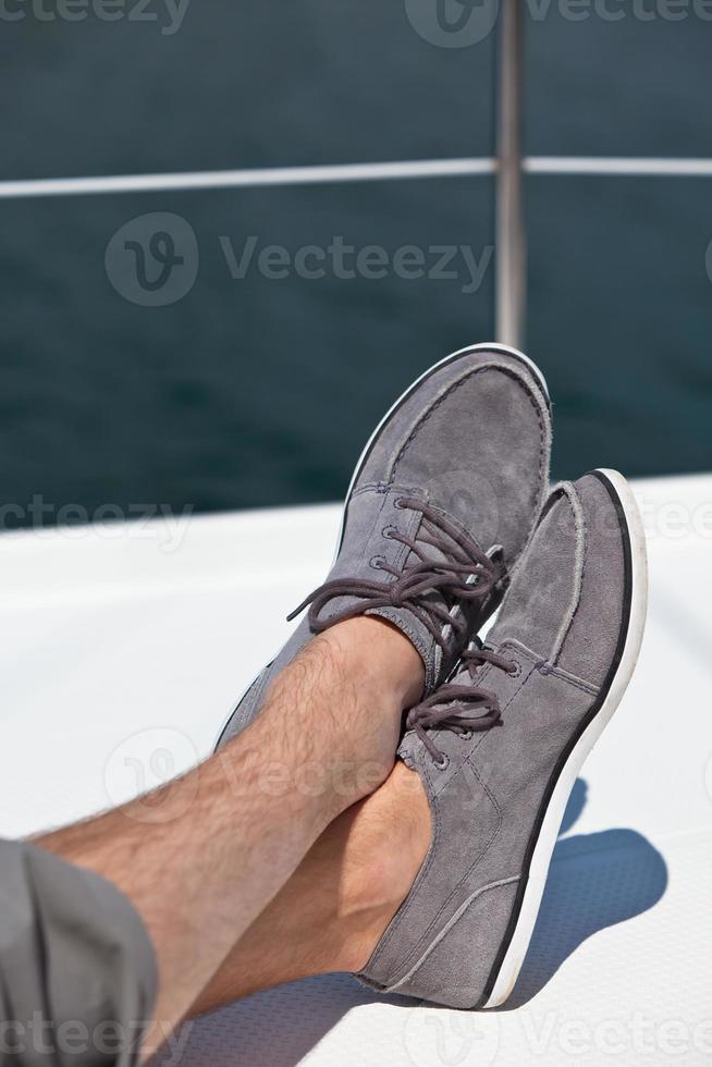 A pair of hairy man legs in topsiders photo