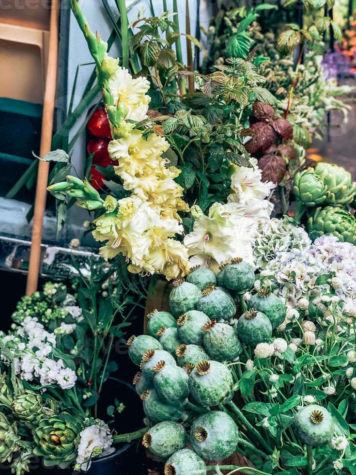 Decorative giant poppy heads in small florist shop photo