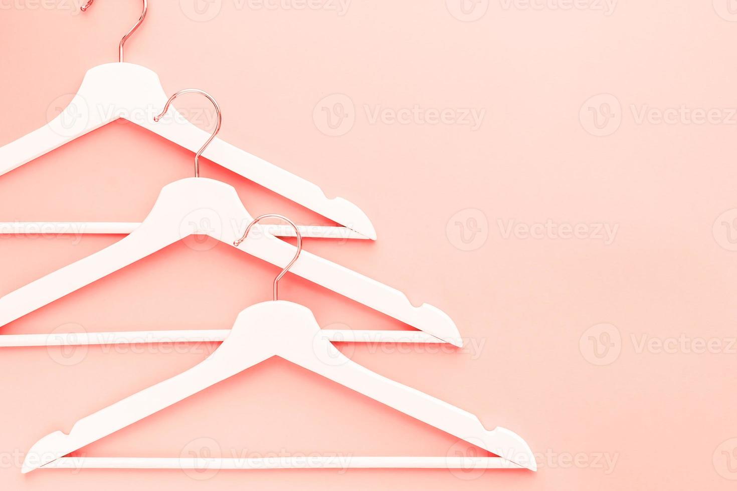 Wooden hangers toned living coral color photo