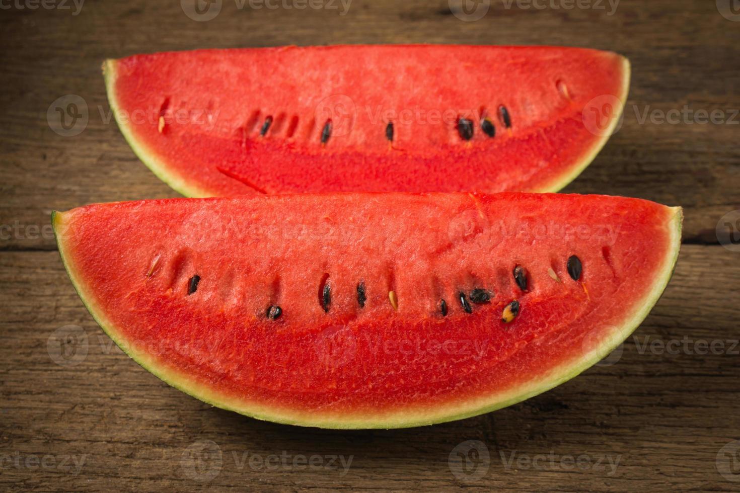 slice of ripe watermelon on old wood photo