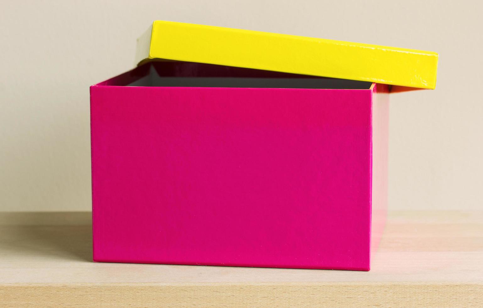 colorful paper box on wooden table photo