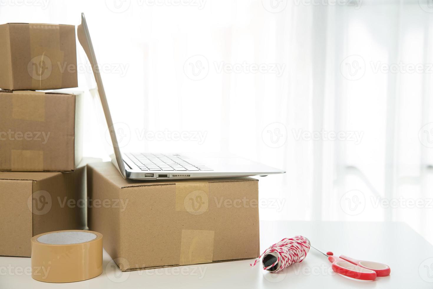 Equipments for SME online business, delivery business laptop, barcode, boxes, checking product on stocks or cardboard parcels. Small business working at home office. delivery service product at home. photo
