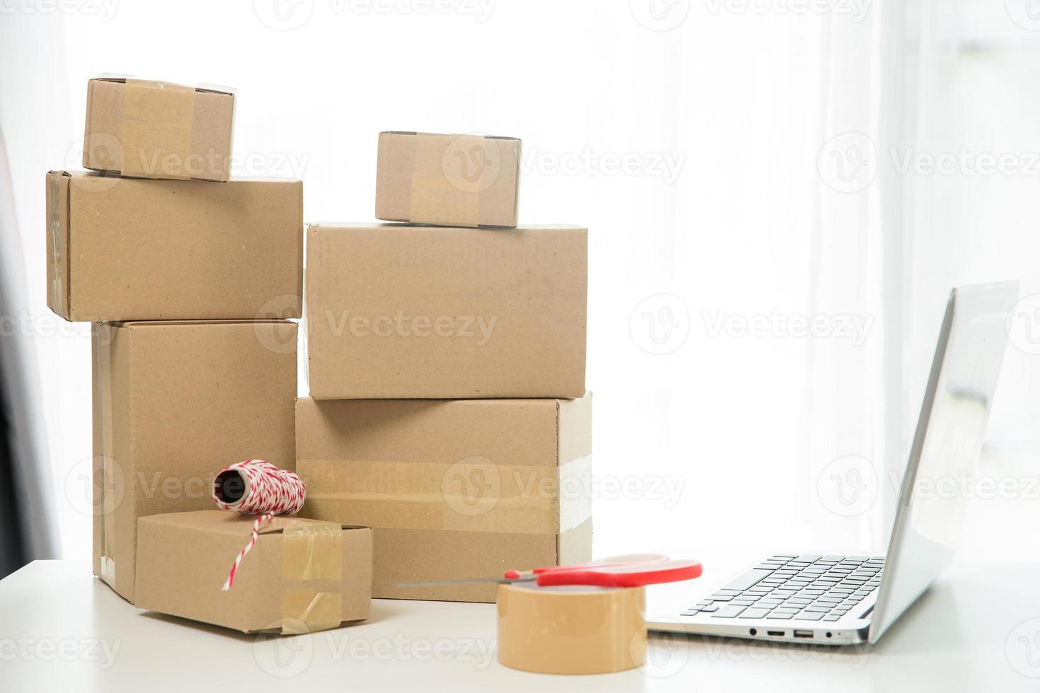 Equipments for SME online business, delivery business laptop, barcode, boxes, checking product on stocks or cardboard parcels. Small business working at home office. delivery service product at home. photo