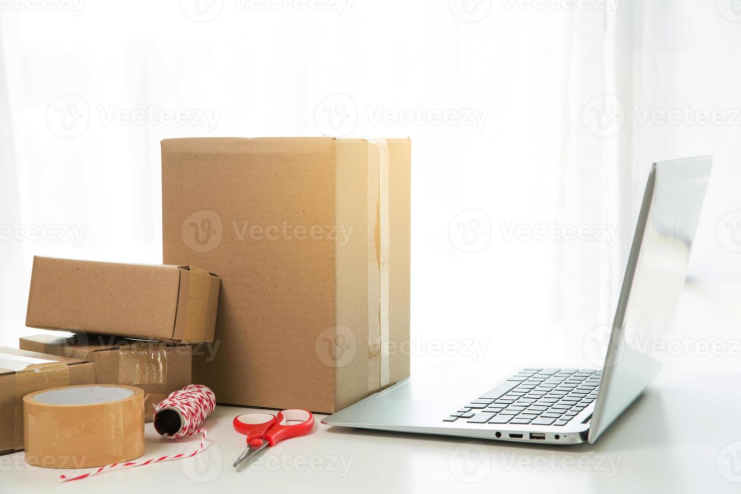 Equipments for SME online business, delivery business laptop, barcode, boxes, checking product on stocks or cardboard parcels. Small business working at home office. delivery service product at home. photo