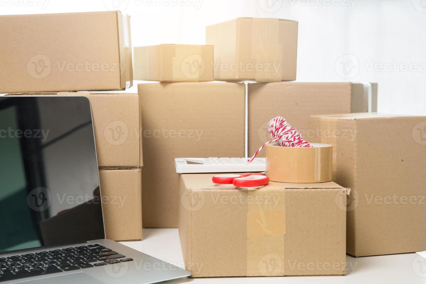 Equipments for SME online business, delivery business laptop, barcode, boxes, checking product on stocks or cardboard parcels. Small business working at home office. delivery service product at home. photo