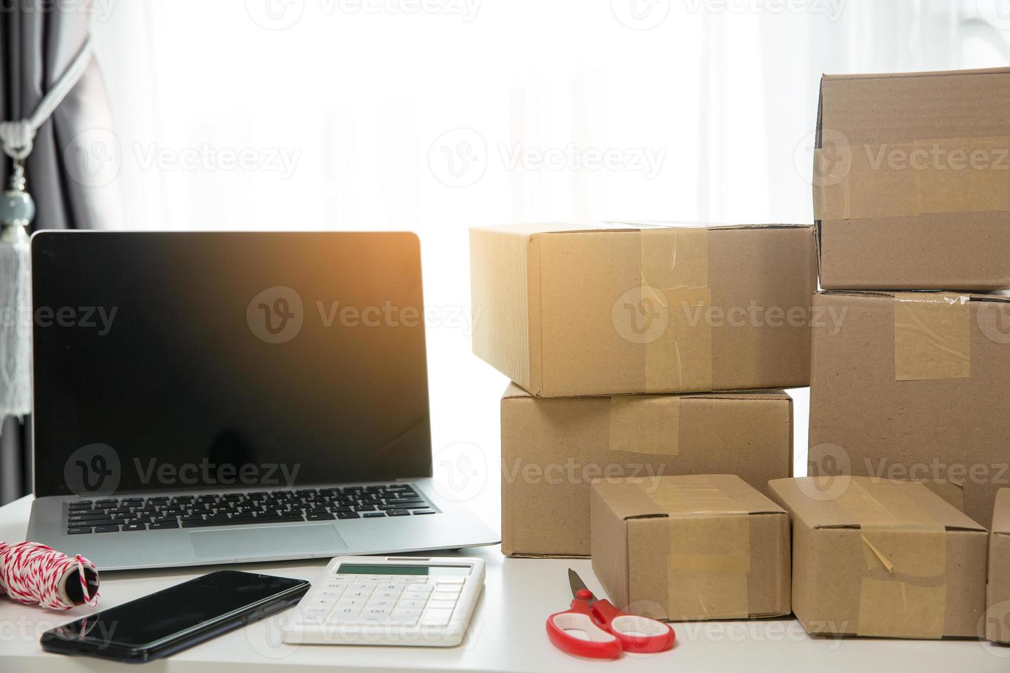 Equipments for SME online business, delivery business laptop, barcode, boxes, checking product on stocks or cardboard parcels. Small business working at home office. delivery service product at home. photo