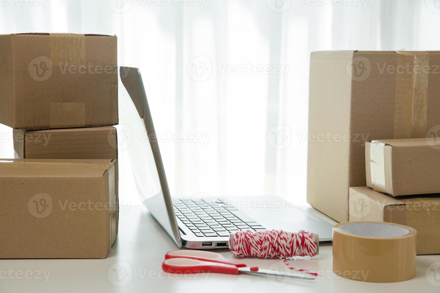 Equipments for SME online business, delivery business laptop, barcode, boxes, checking product on stocks or cardboard parcels. Small business working at home office. delivery service product at home. photo
