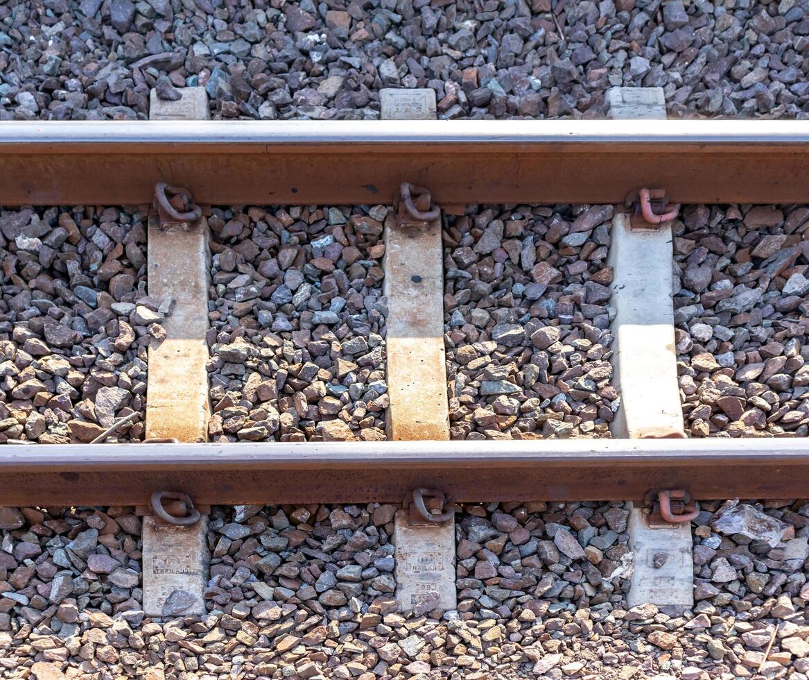 Close up of train tracks made of steel and concrete. photo